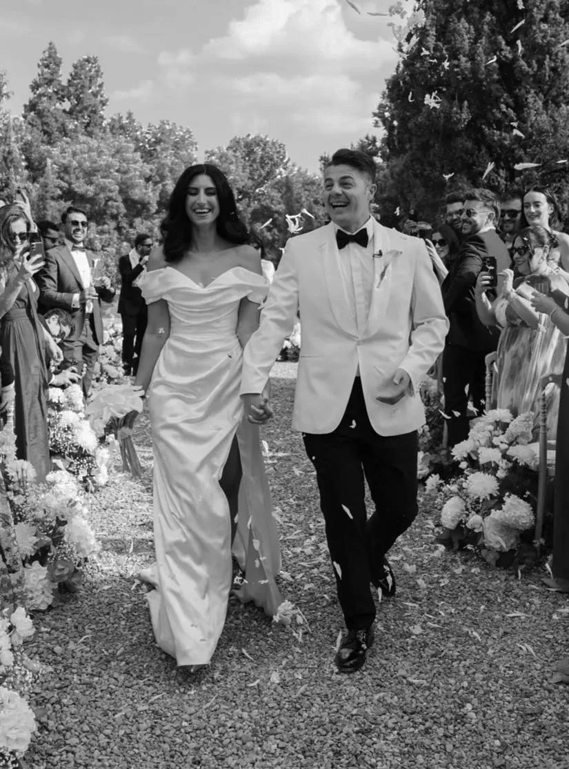 Morgan Davies Bridal Сouple wearing a white gown and a black suit