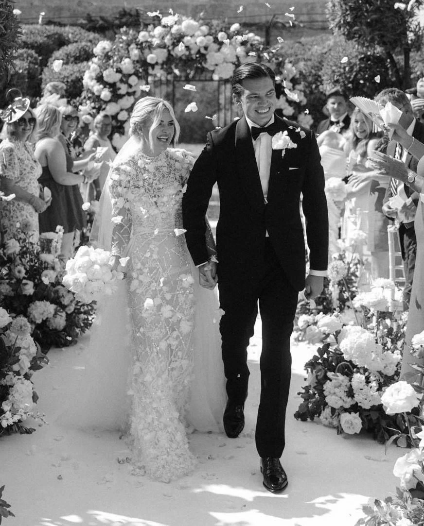 Morgan Davies Bridal Сouple wearing a white gown and a black suit