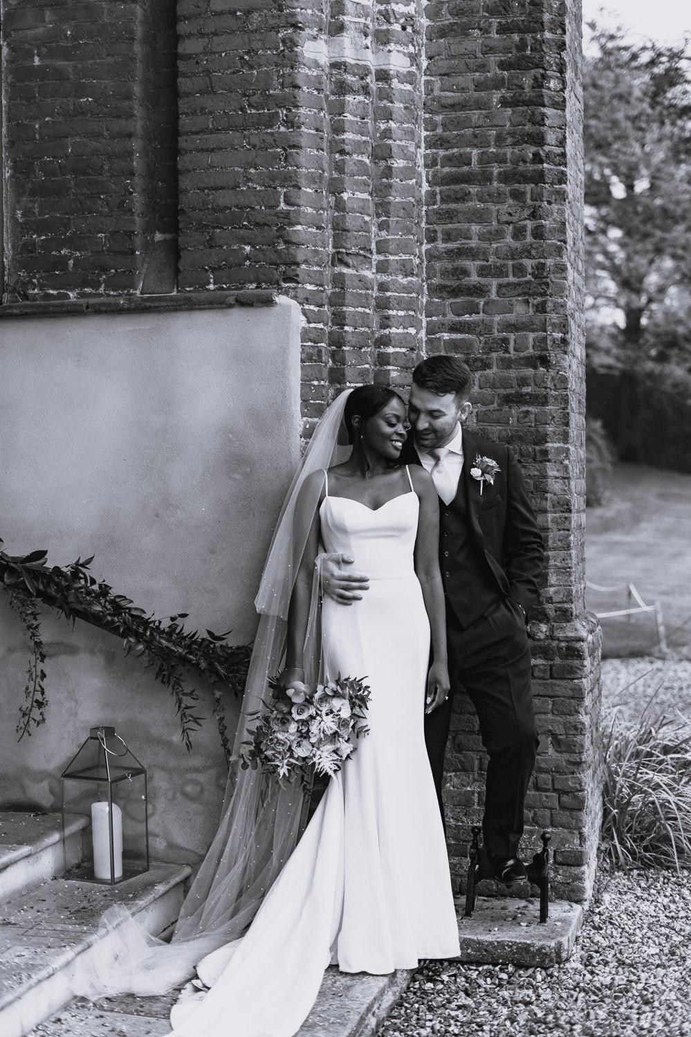 Morgan Davies Bridal Сouple wearing a white gown and a black suit
